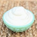 angle view of whipped cream in green bowl