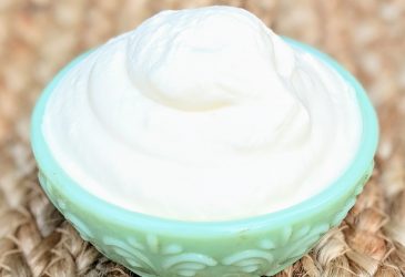 angle view of whipped cream in green bowl