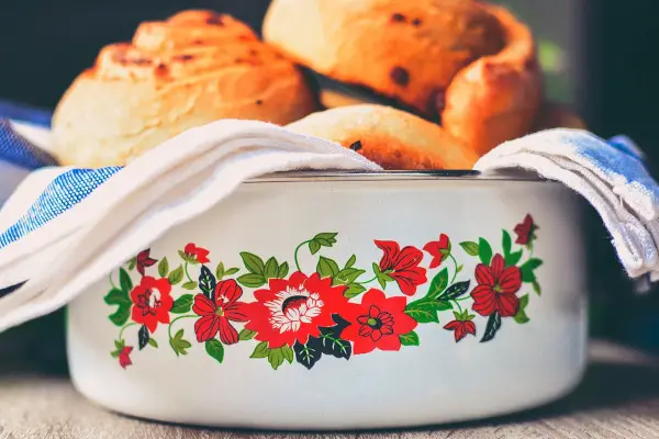 Curating a home. Homemade rolls rest in a vintage bowl.