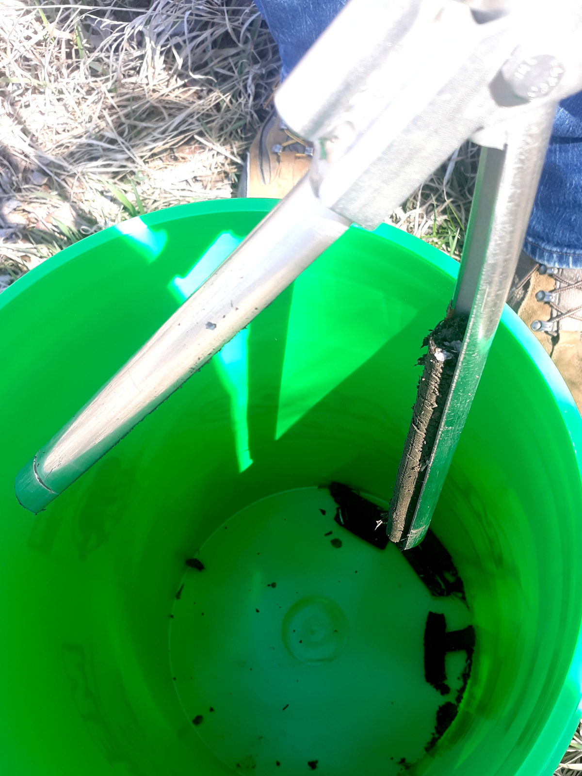 putting soil sample in bucket