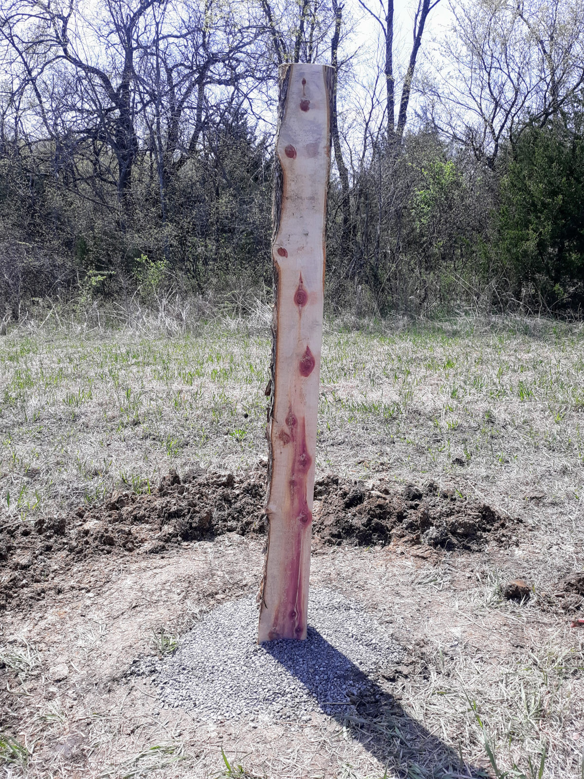 finished post in post hole for horse fence