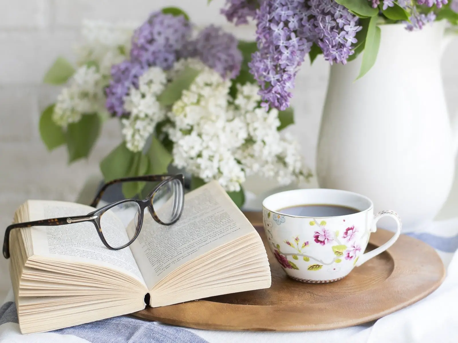 tea time with a book and liilac flowers