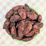 top view of cocoa roasted almonds in green bowl