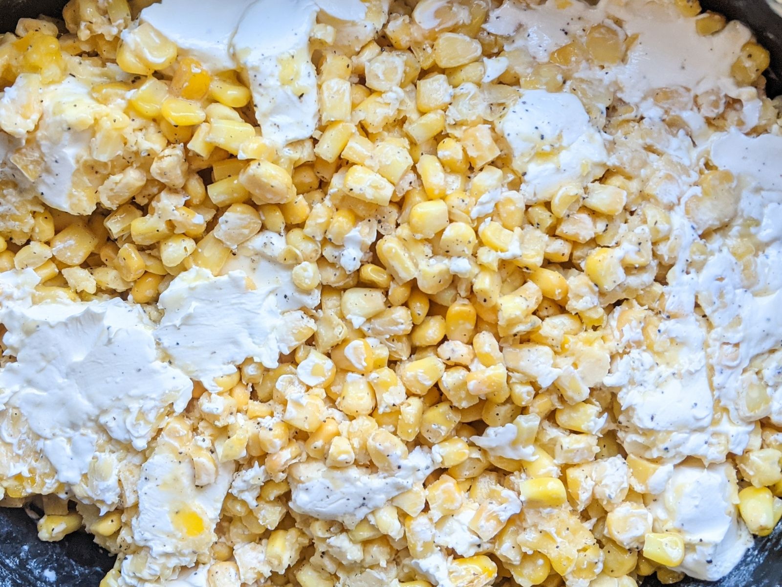 creamed corn ingredients mixed together in slow cooker