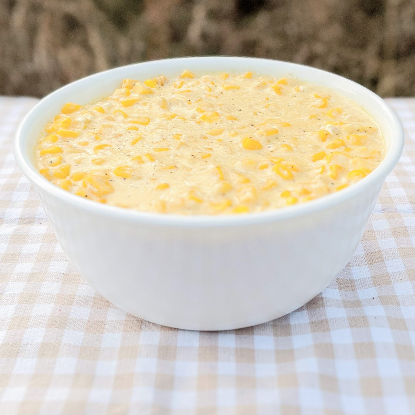 creamed corn in white bowl on table
