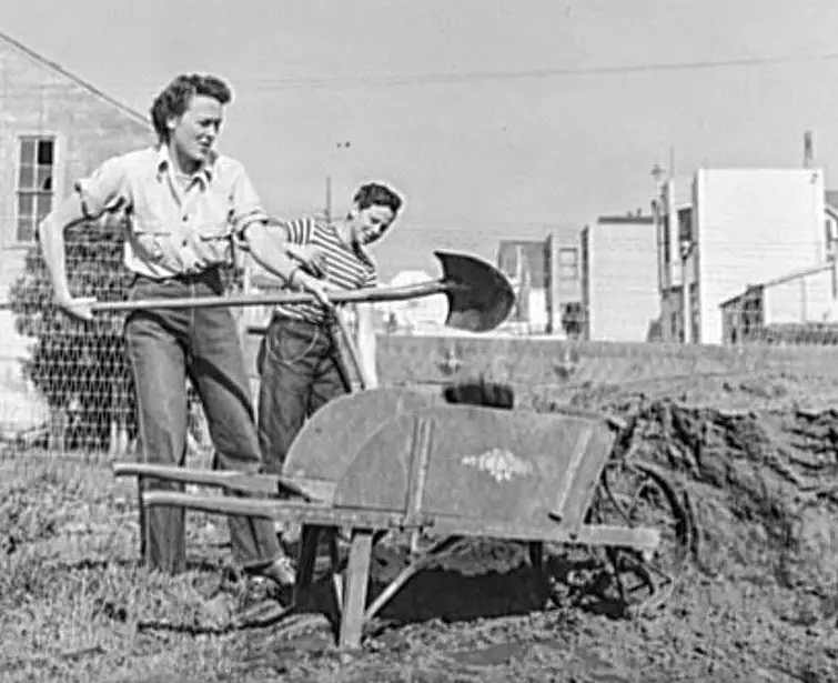 woman and boy working in victory garden