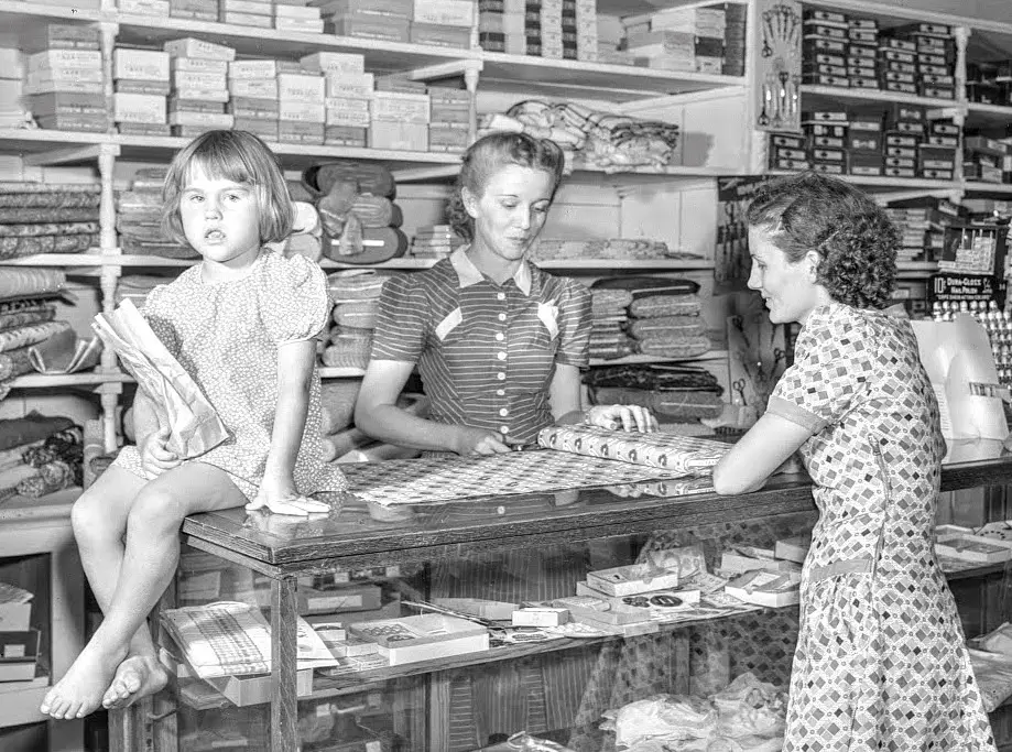 two woman and child at fabric counter