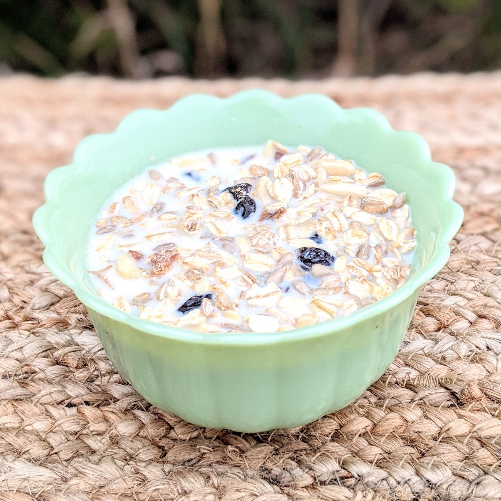 muesli soaking in milk in green bowl