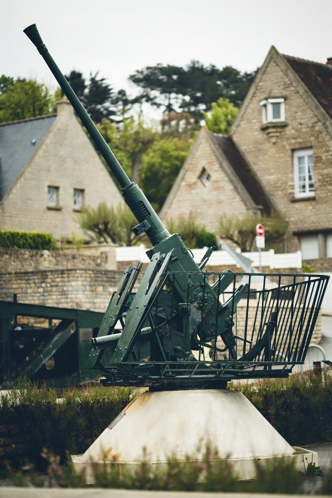 old war war ii machinery with houses in background