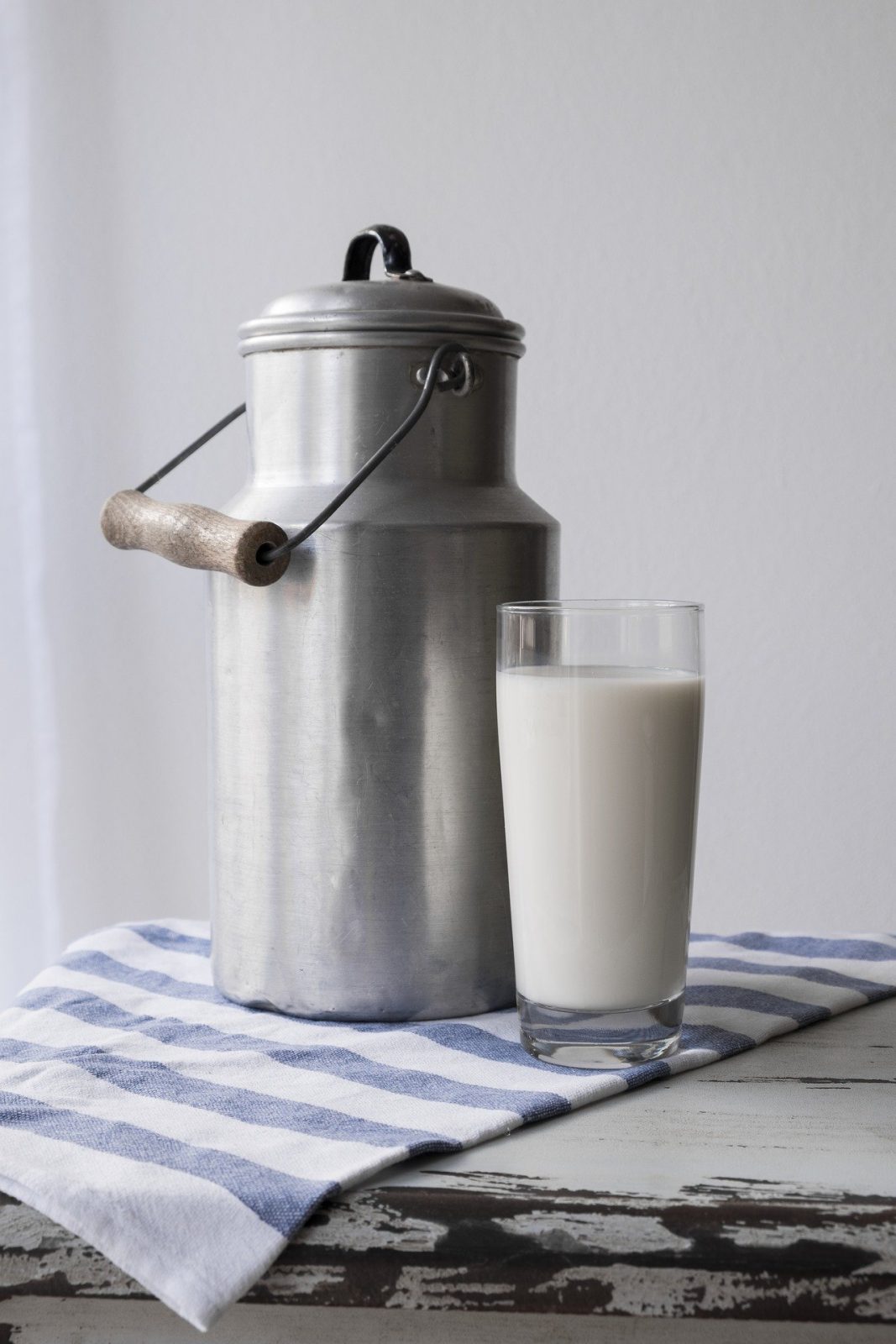 milk carton and cup of milk on table