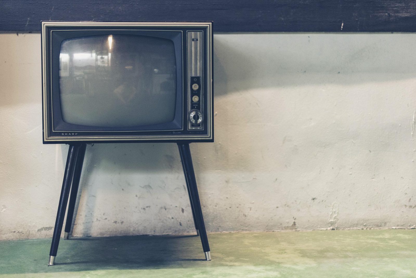 vintage tv in front of white wall