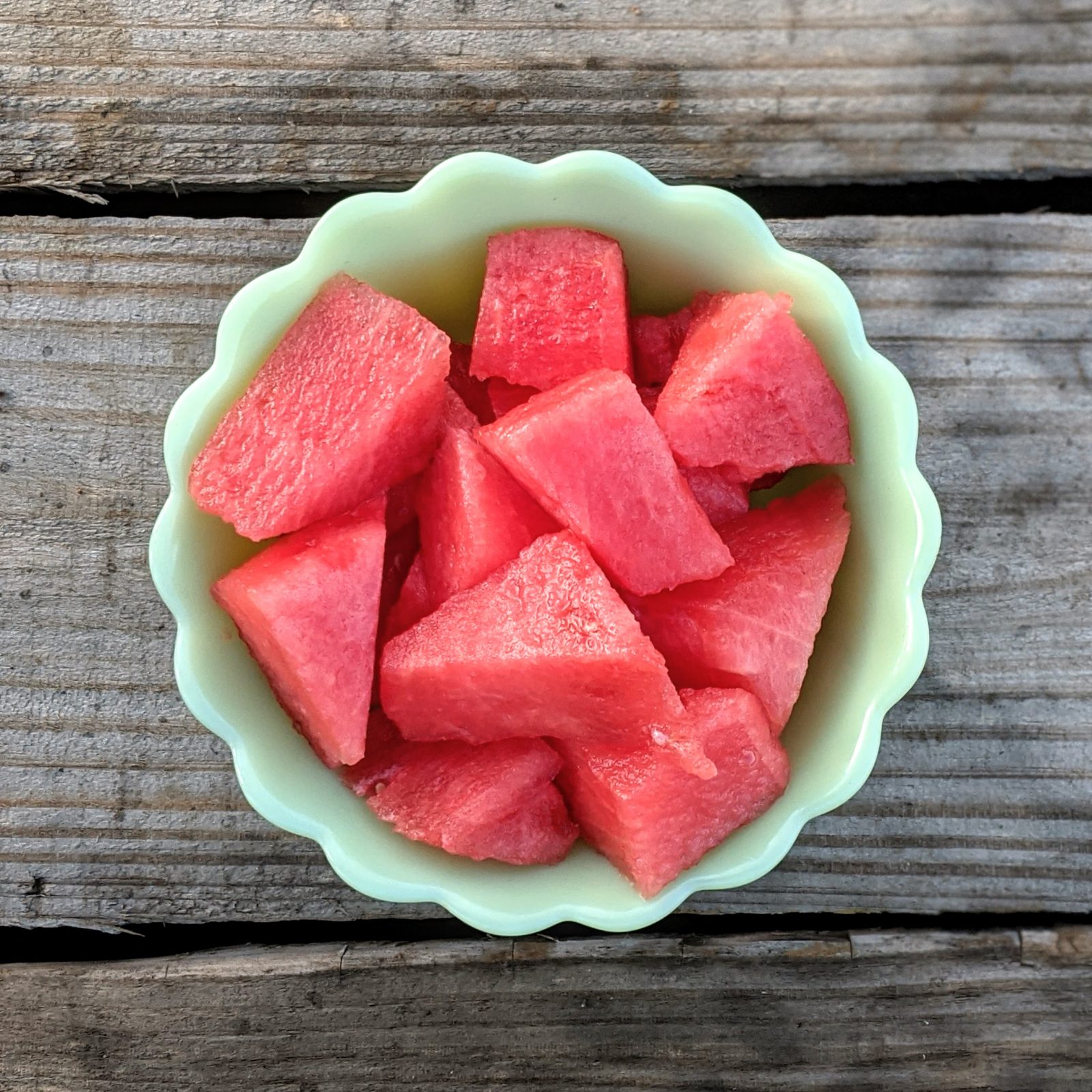 diced watermelon in green bowl