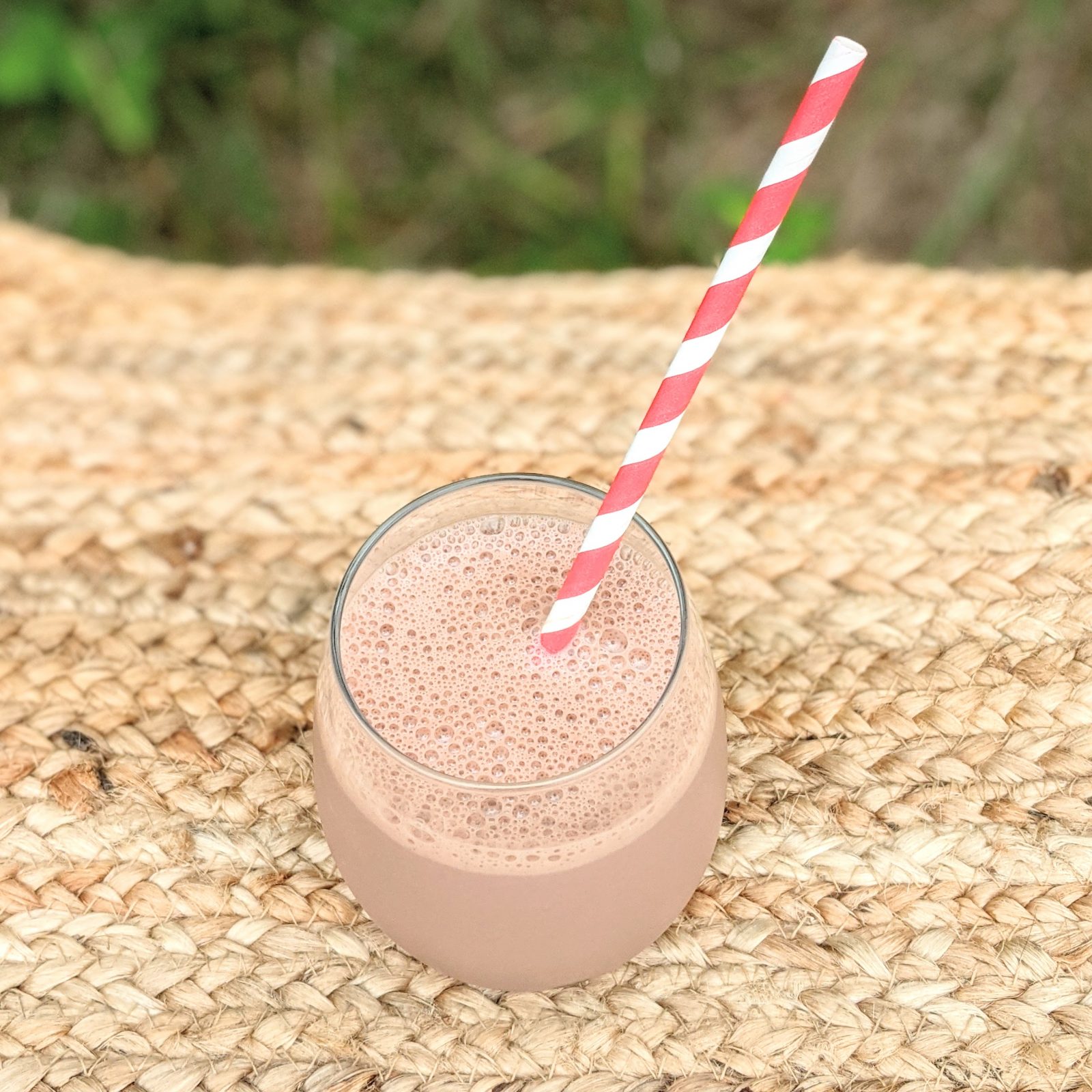 glass of chocolate milk with red and white straw