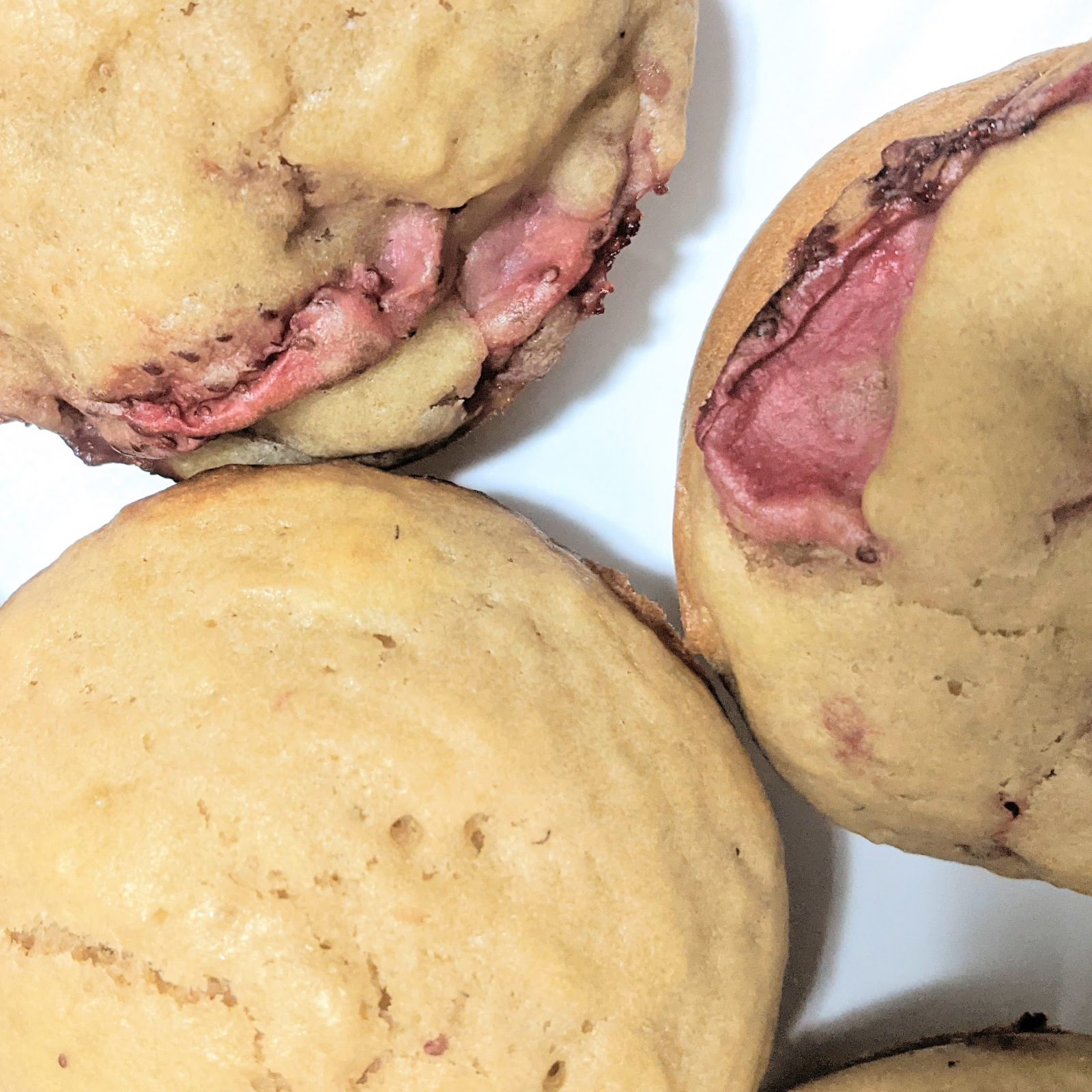 closeup of three strawberry muffins